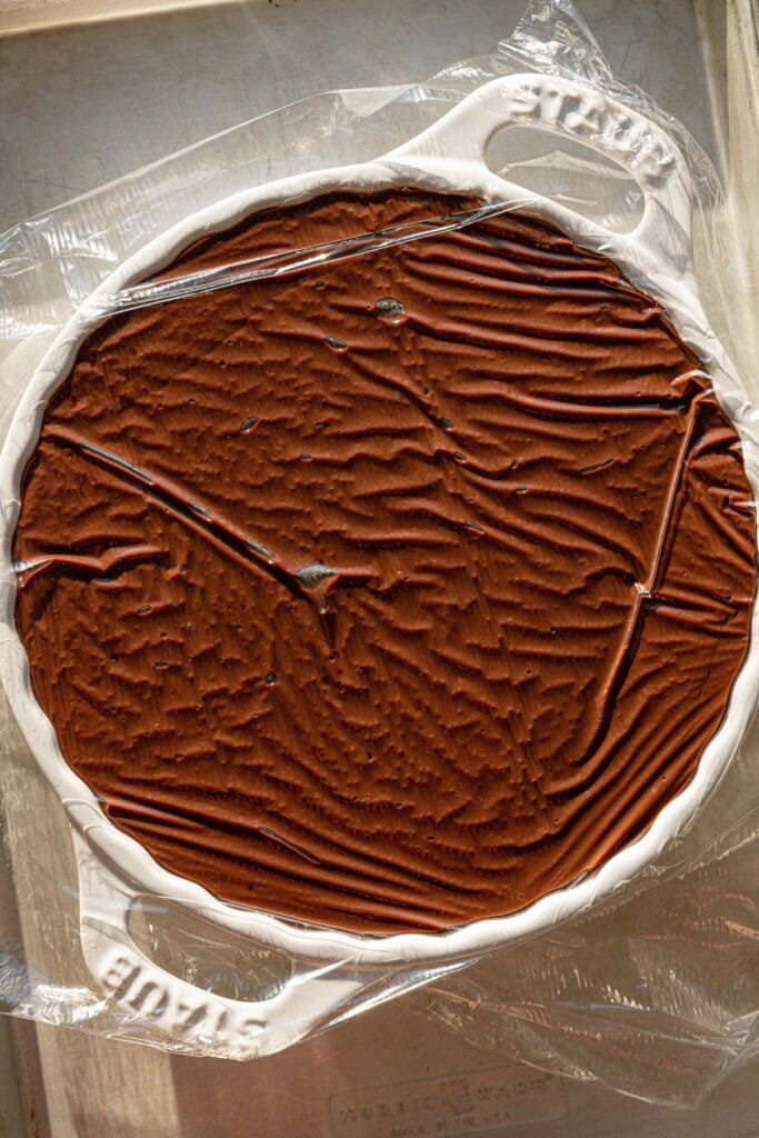 pudding in pan with plastic wrap.