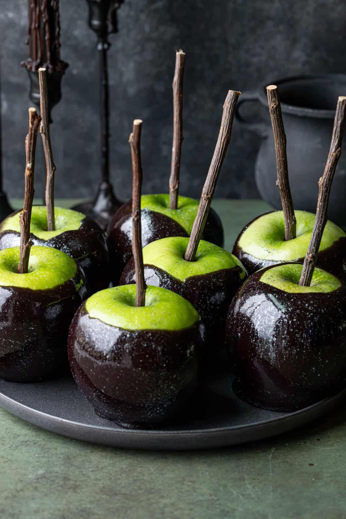 Black Poison Caramel Apples on plate.