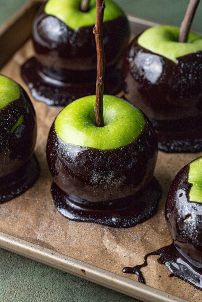 apples dipped in black caramel and dusted with edible glitter.