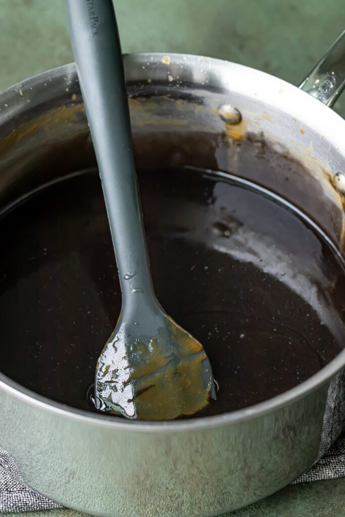black colored caramel in saucepan.