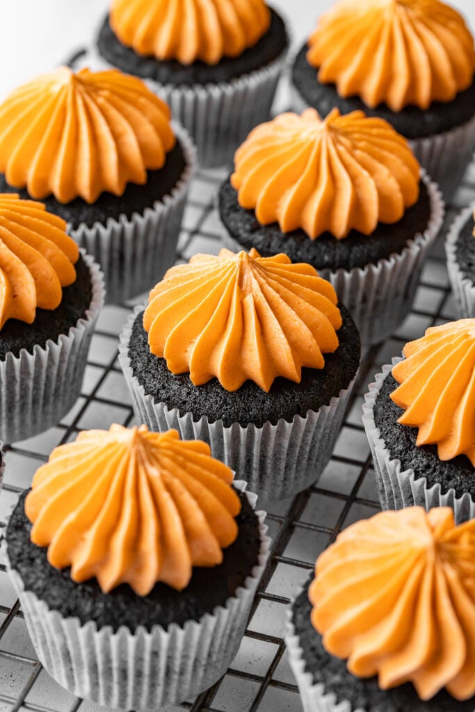 orange buttercream piped onto cupcakes.