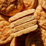 thick and soft snickerdoodles cut in half and lined up to show inside texture.