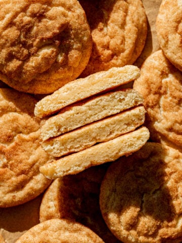 thick and soft snickerdoodles cut in half and lined up to show inside texture.