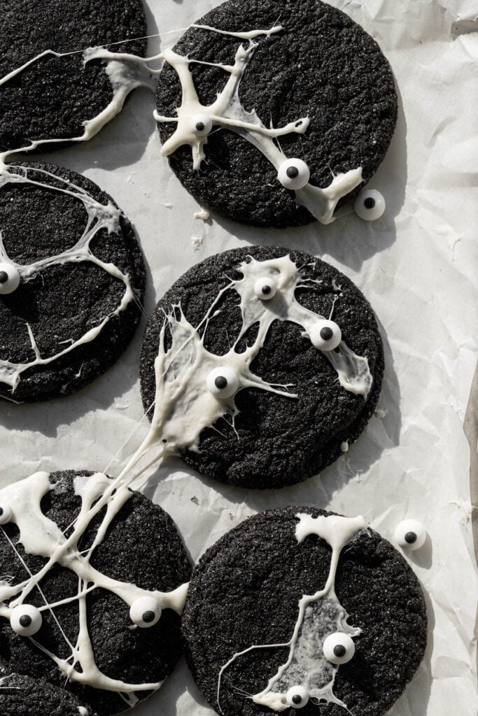 spiderweb black velvet cheesecake cookies on baking sheet.