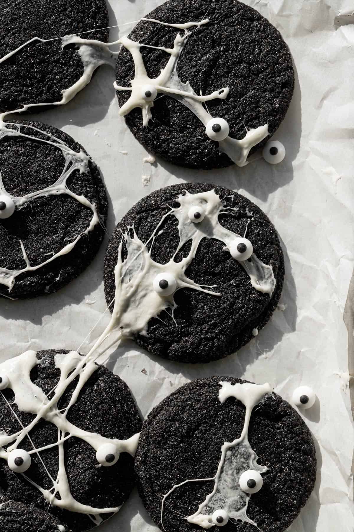 spiderweb black velvet cheesecake cookies on baking sheet.
