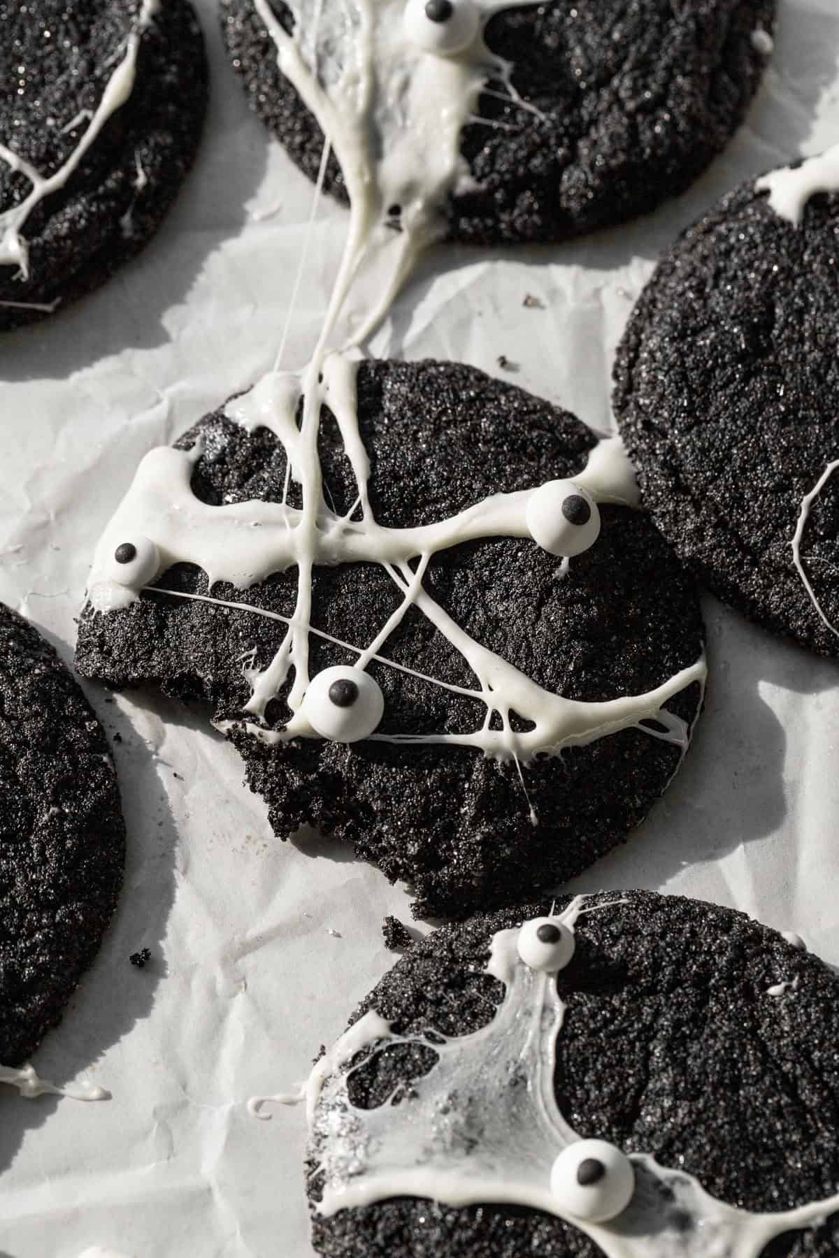 bite taken out of Spiderweb Black Velvet Cheesecake Cookie.